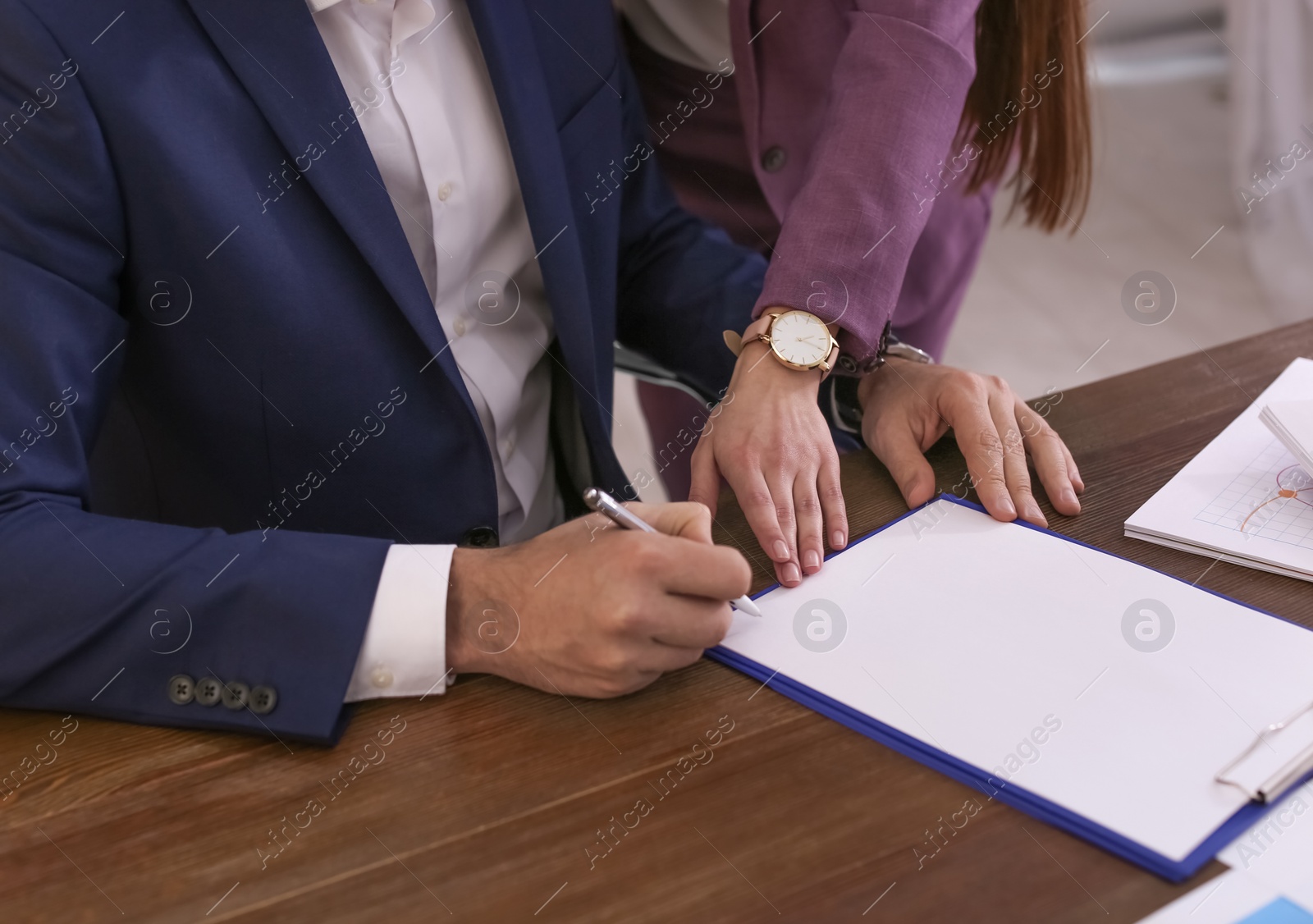 Photo of Businessman and assistant working with documents at table, closeup