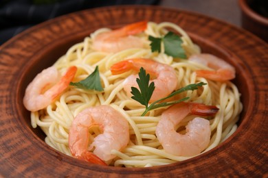 Photo of Tasty spaghetti with shrimps and parsley on plate, closeup