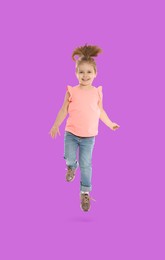 Image of Happy cute girl jumping on violet background