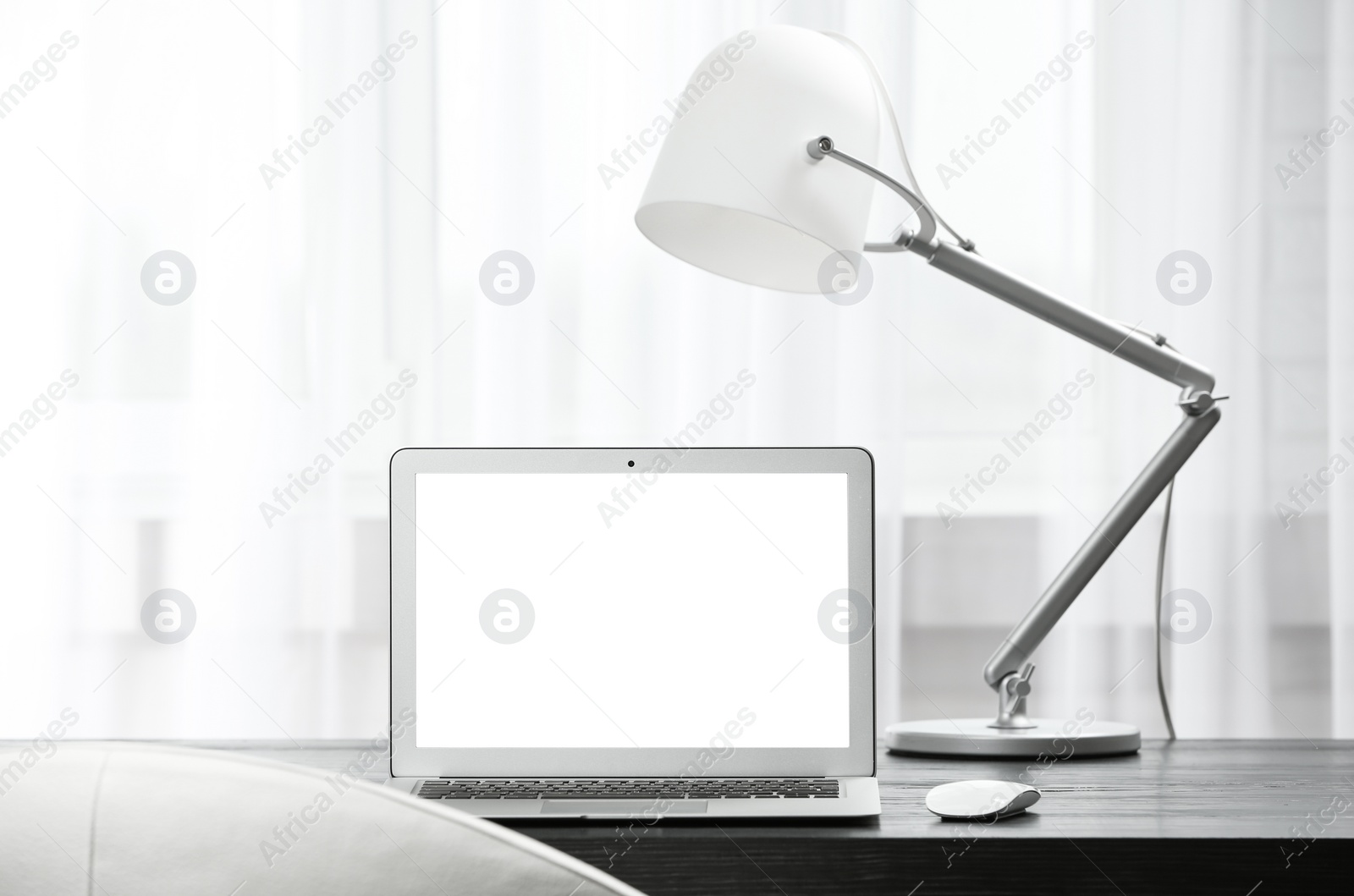 Photo of Laptop on desk in home office. Comfortable workplace