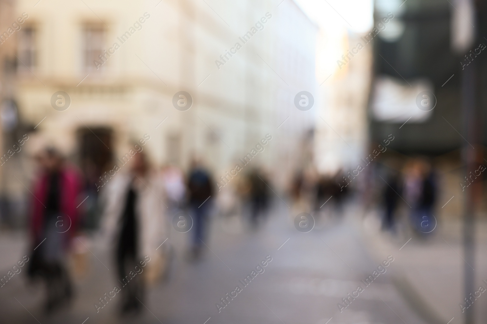 Photo of Blurred view of people walking on city street