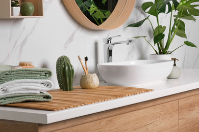 Photo of Stylish vessel sink on light countertop in modern bathroom