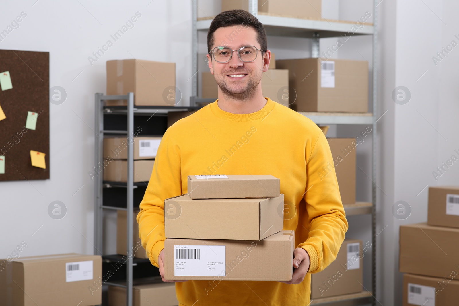 Photo of Seller with parcels in office. Online store