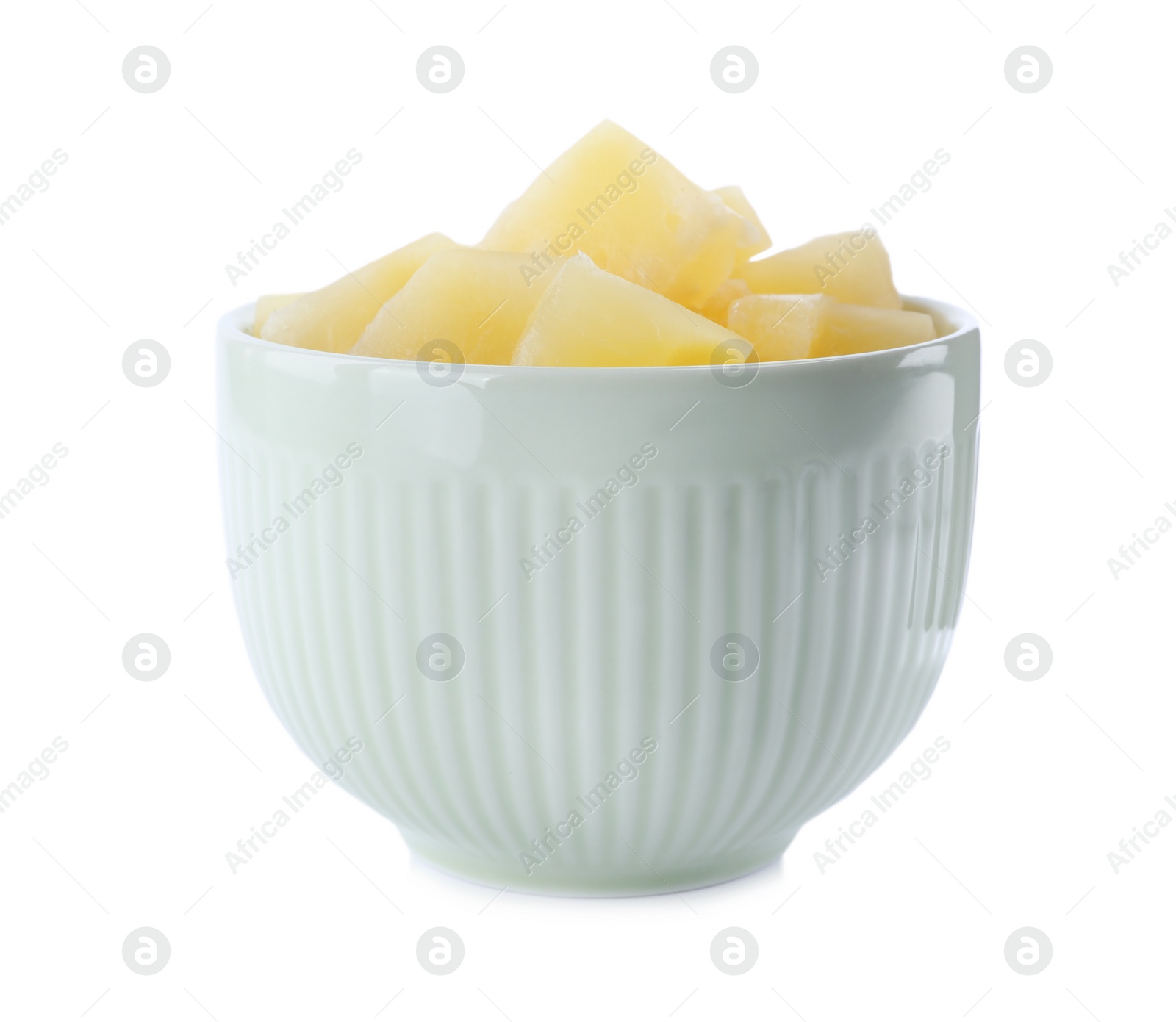 Photo of Pieces of delicious canned pineapple in bowl on white background