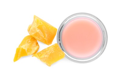 Photo of Lip balm and natural beeswax on white background, top view