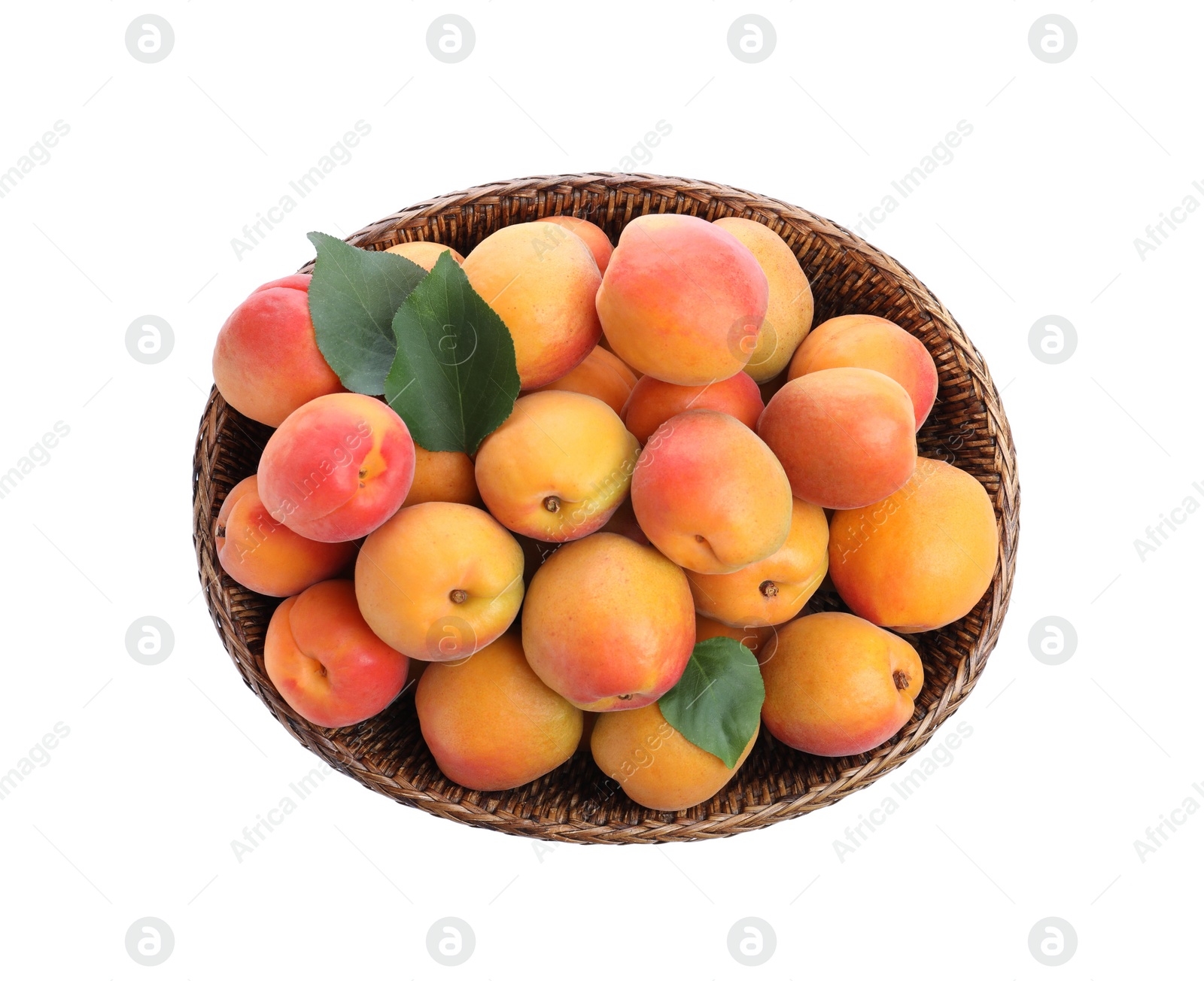 Photo of Delicious ripe apricots in wicker bowl isolated on white, top view