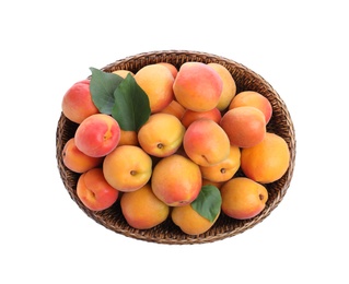 Photo of Delicious ripe apricots in wicker bowl isolated on white, top view