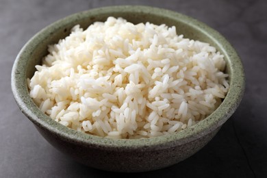 Delicious rice in bowl on grey table, closeup