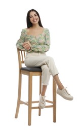 Photo of Beautiful young woman sitting on stool against white background