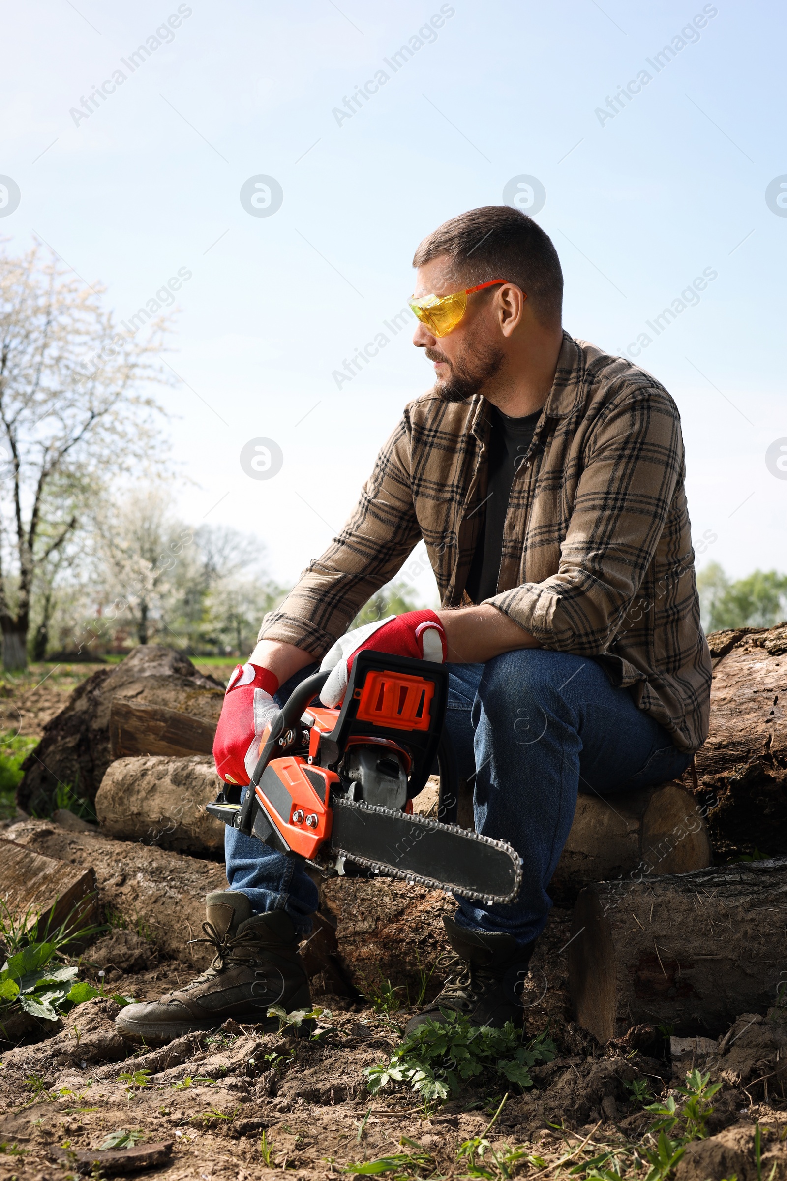 Photo of Man with modern saw on sunny day