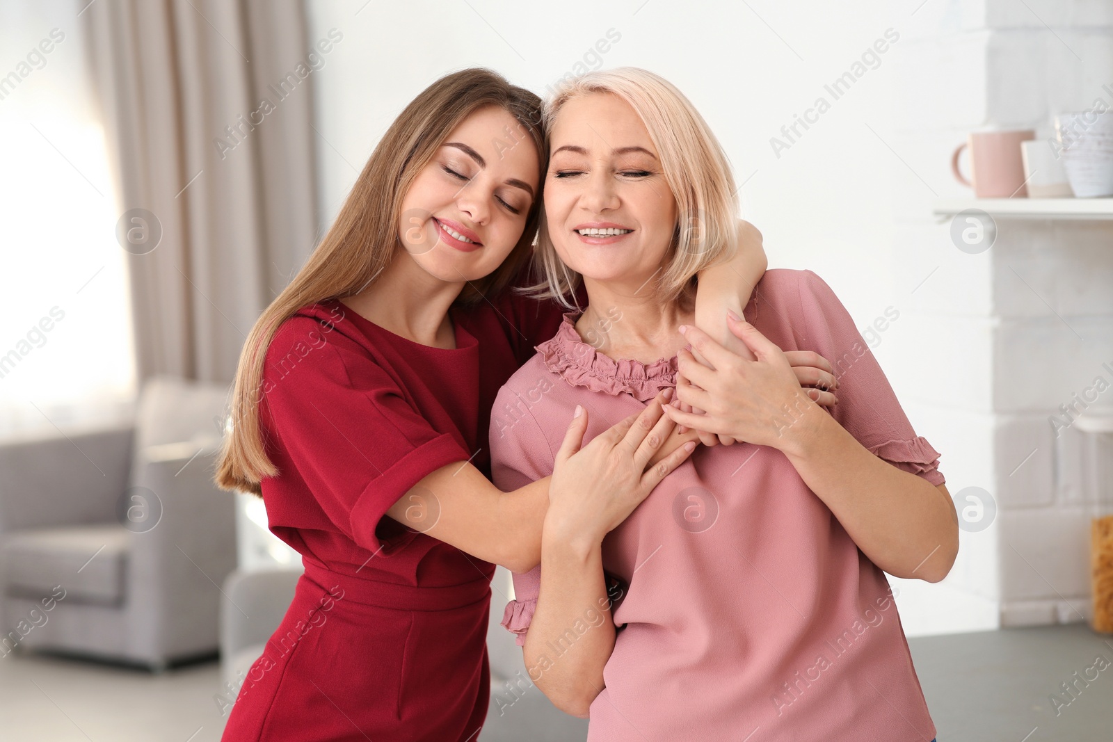 Photo of Portrait of mature woman and her daughter at home