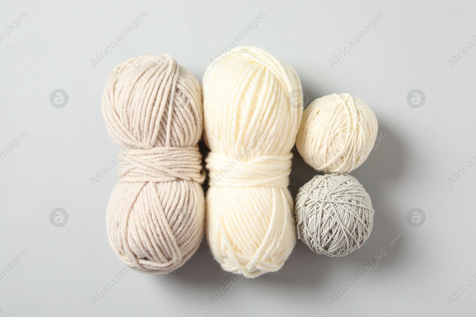 Photo of Soft colorful woolen yarns on white background, flat lay