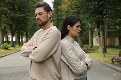 Photo of Upset arguing couple in park. Relationship problems