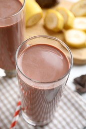 Photo of Fresh yummy chocolate milk in glass on table, closeup