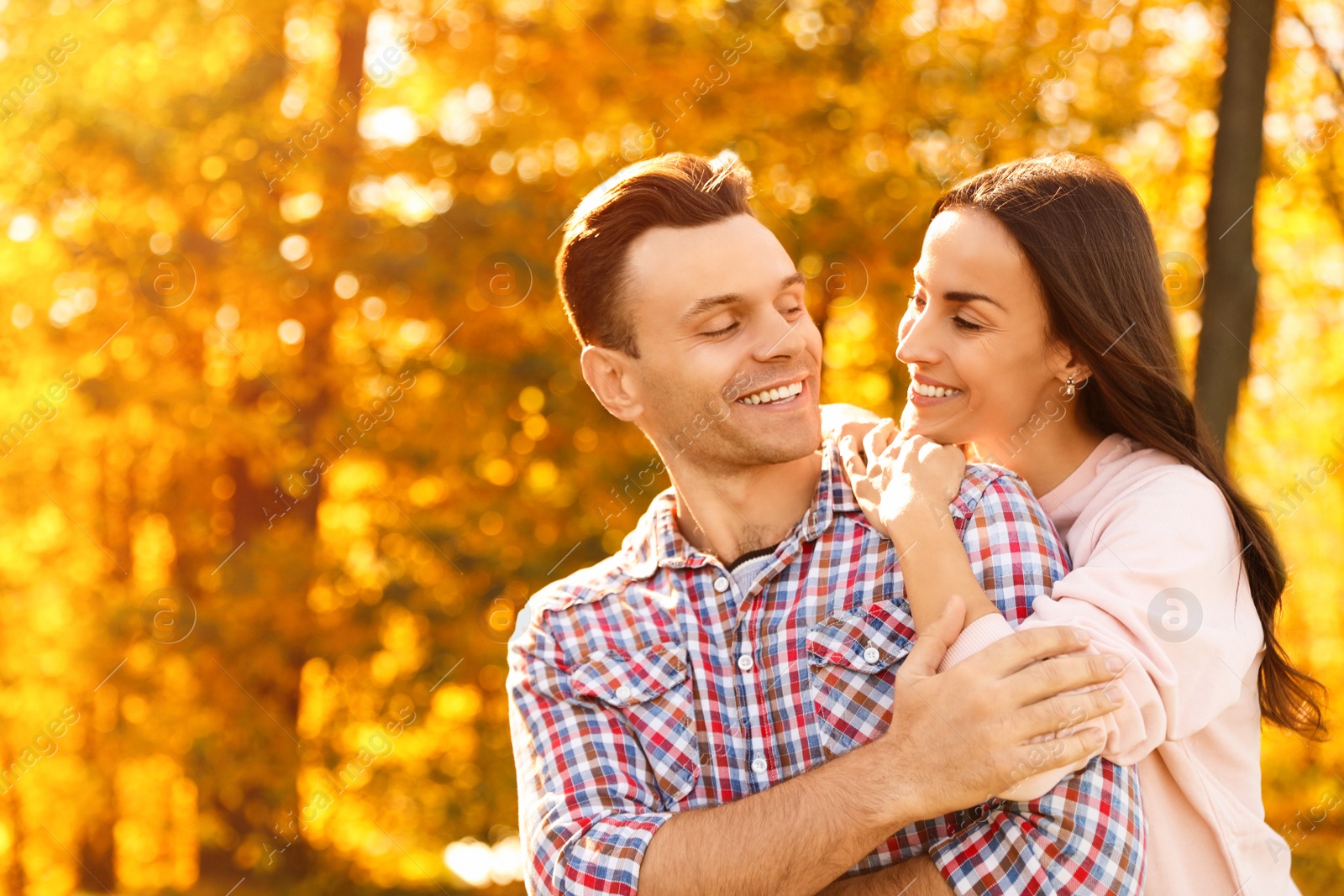 Photo of Happy couple in sunny park. Autumn walk