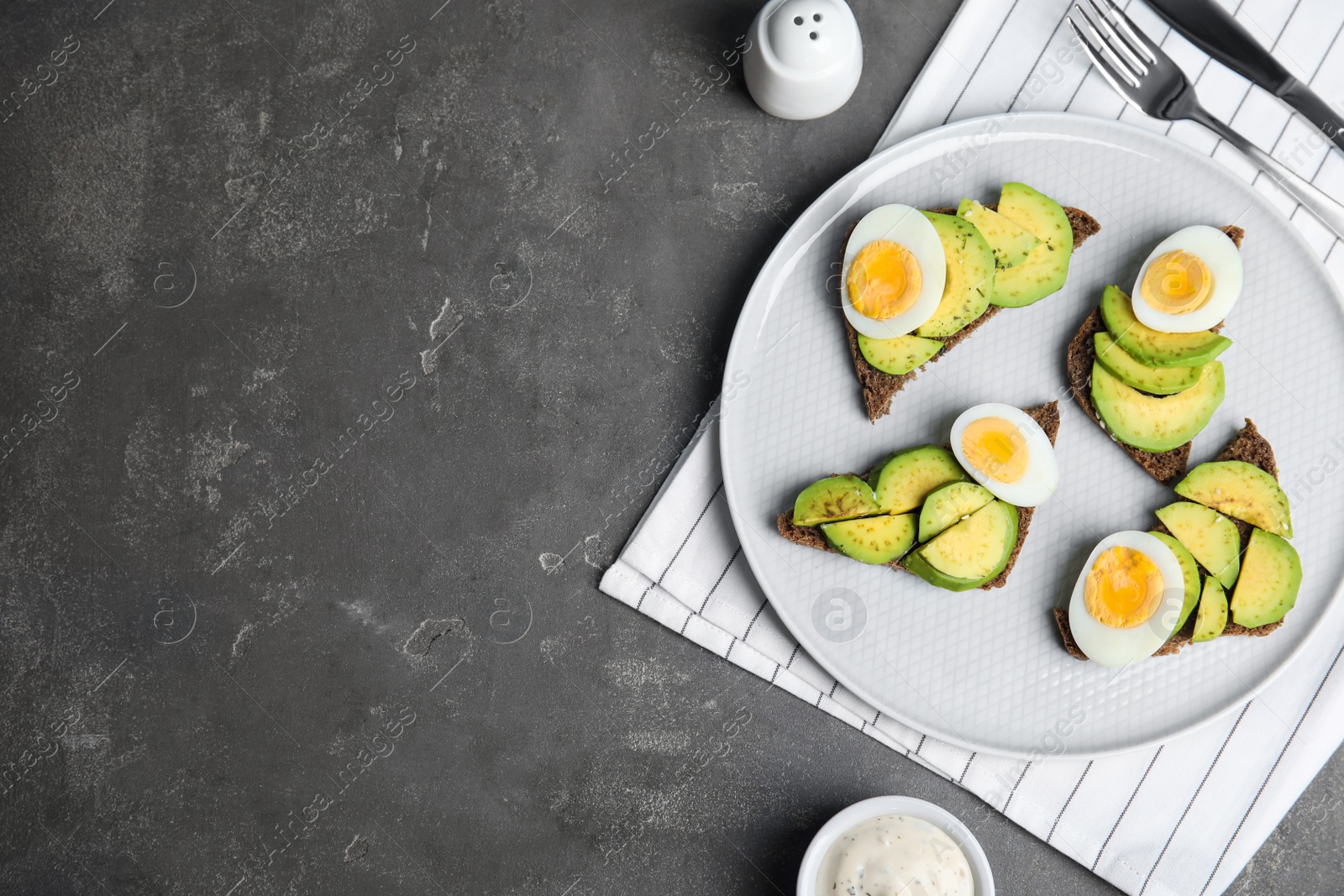 Photo of Flat lay composition with avocado toasts on grey table. Space for text