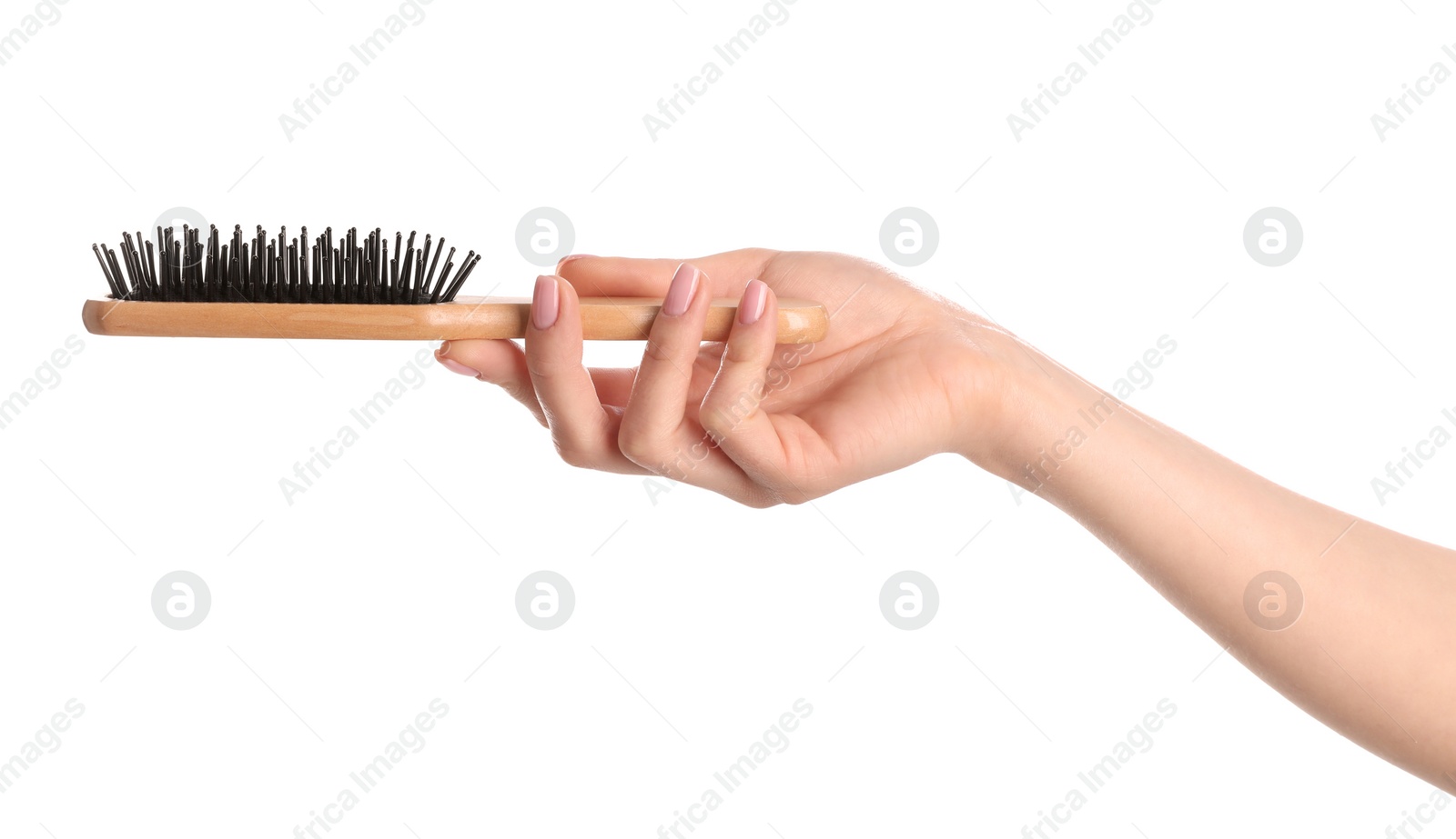 Photo of Woman holding wooden hair brush against white background, closeup