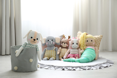 Photo of Funny stuffed toys on floor. Decor for children's room interior