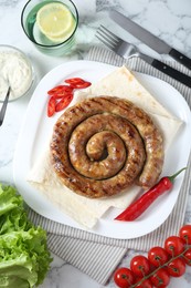 Photo of Tasty homemade sausage with chili pepper and lavash served on white marble table, flat lay