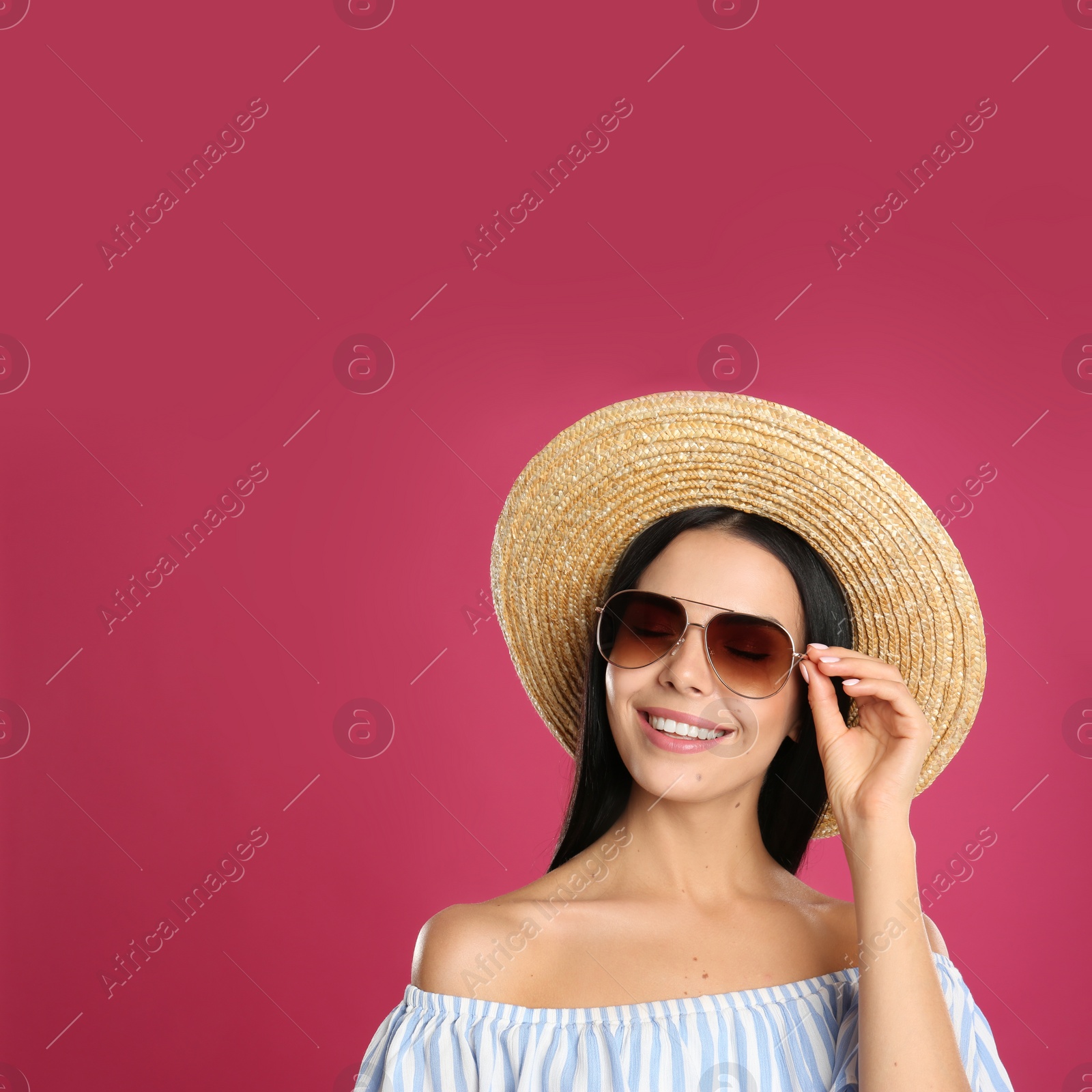 Photo of Beautiful woman wearing sunglasses on pink background. Space for text