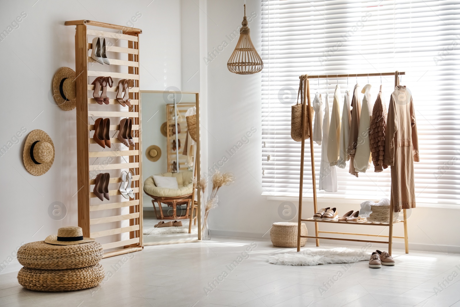 Photo of Modern dressing room interior with racks of stylish women's clothes and shoes