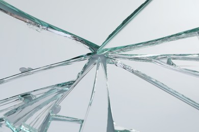 Photo of Broken mirror with many cracks as background, closeup view