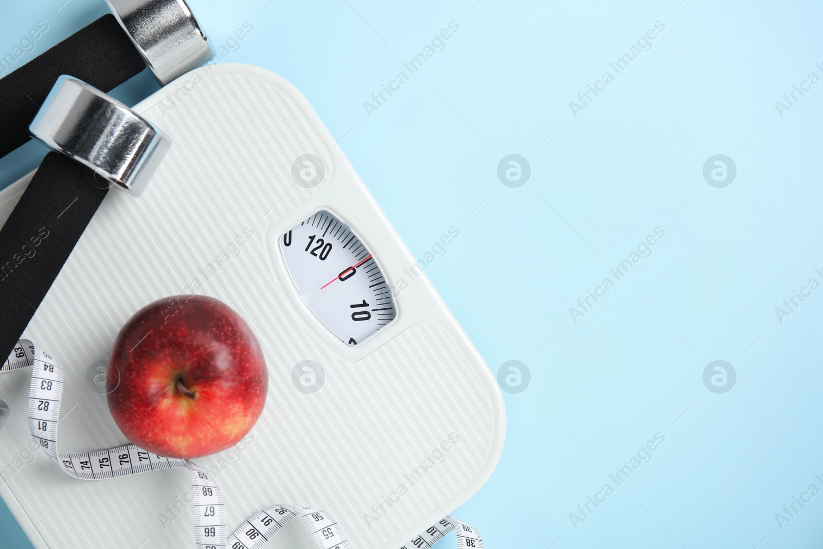 Flat lay composition with scales on light blue background, space for text Photo of Flat lay composition with scales on light blue background, space for text