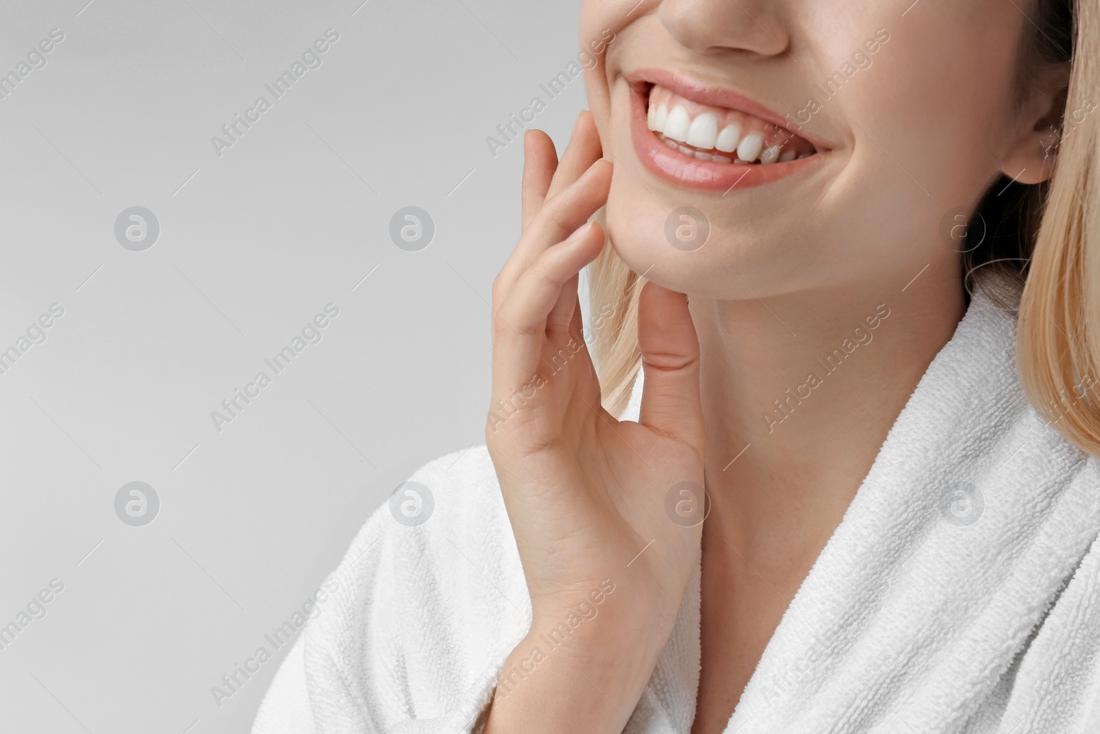 Photo of Young woman with silky skin on light background, closeup