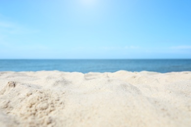 Sandy beach near sea on sunny day