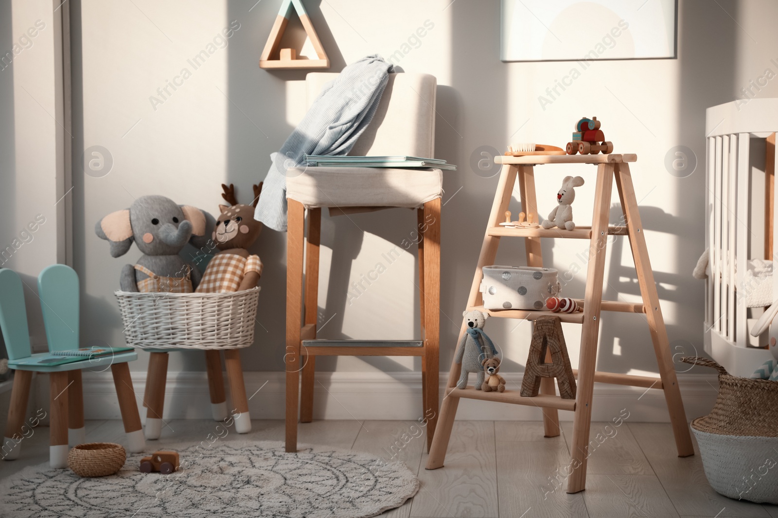 Photo of Beautiful baby room interior with stylish wooden ladder