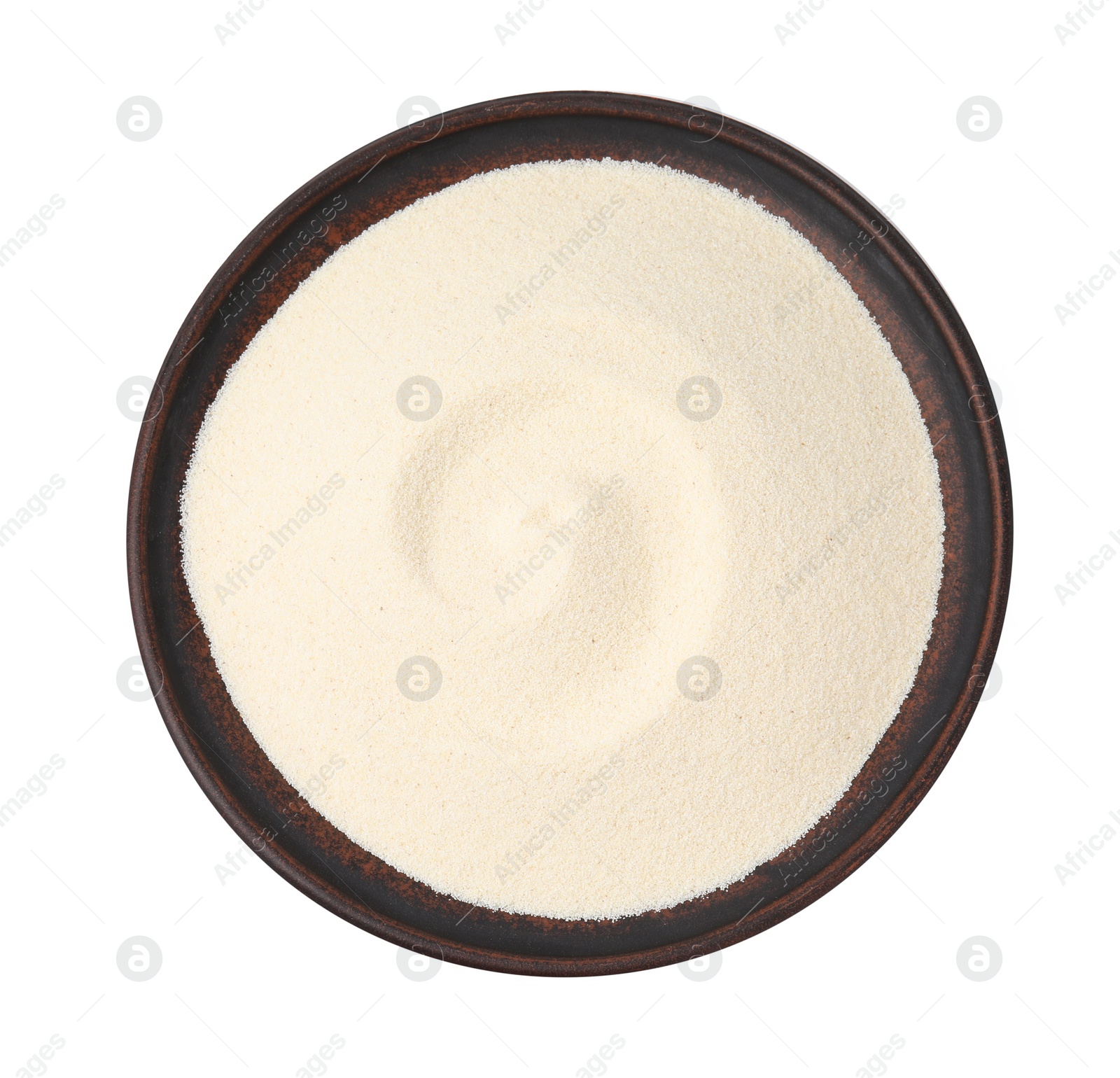 Photo of Bowl of uncooked organic semolina isolated on white, top view