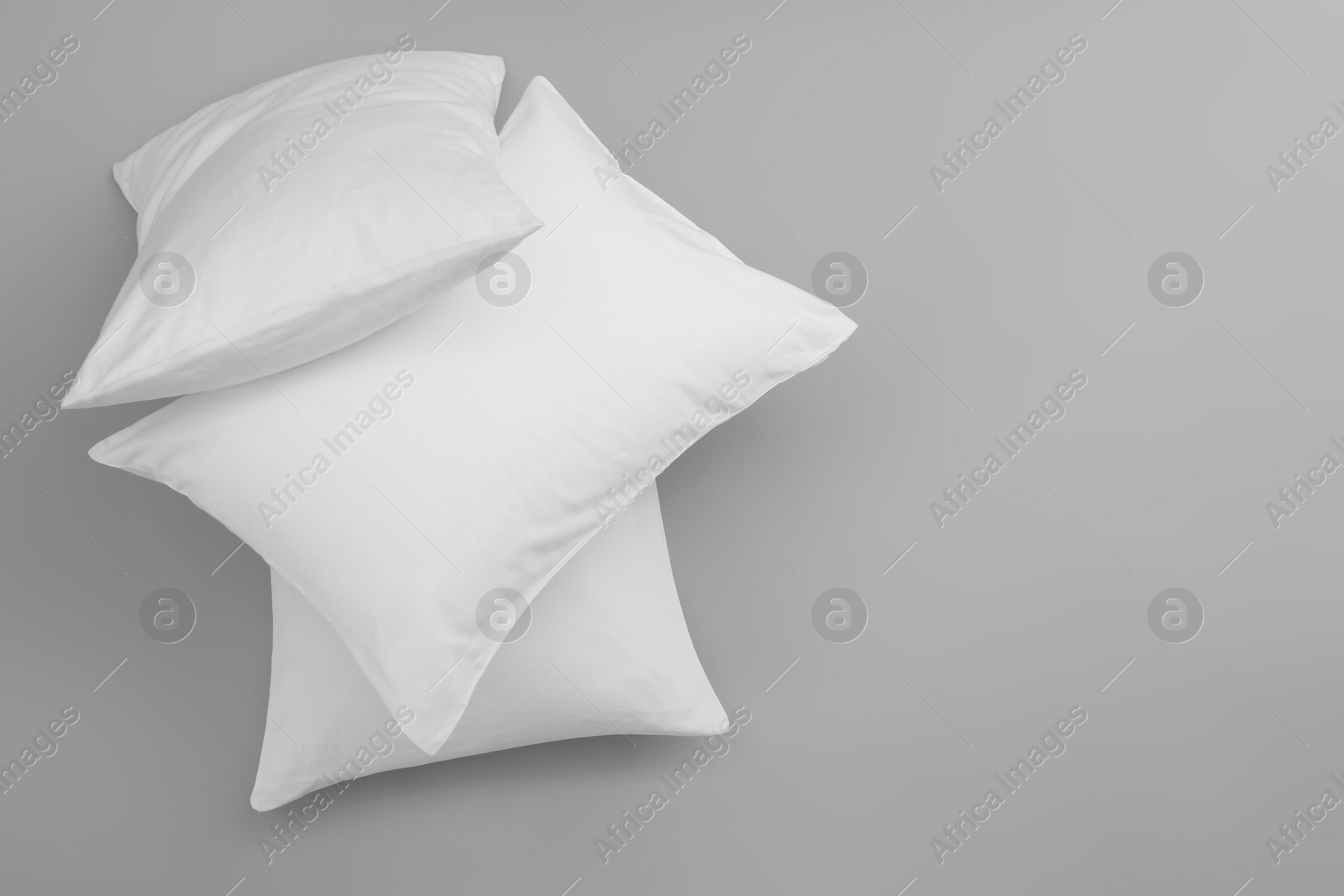 Photo of Clean soft bed pillows on grey background, top view