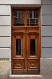 View of building with big vintage wooden door. Exterior design