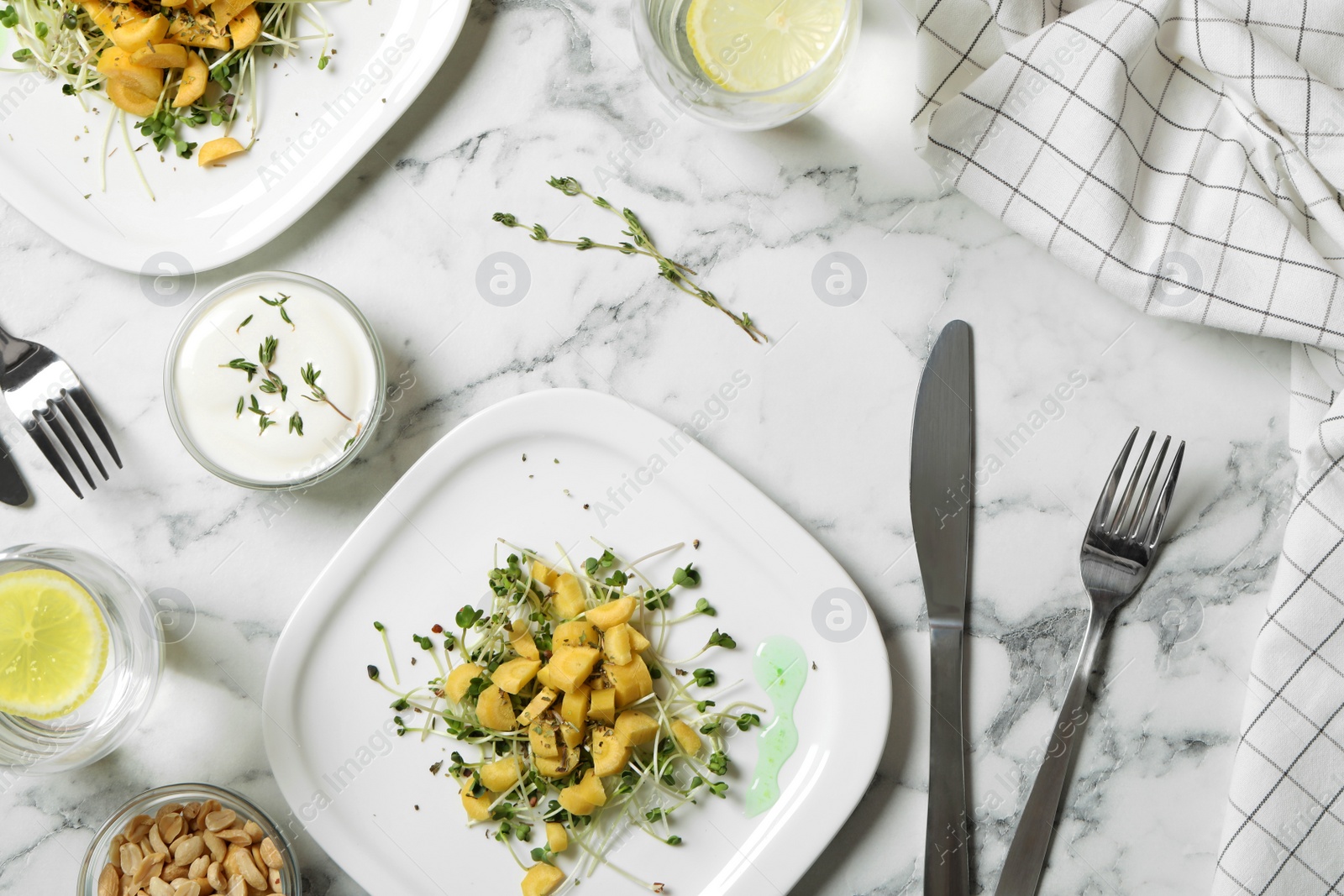 Photo of Delicious fresh carrot salads served on white marble table, flat lay