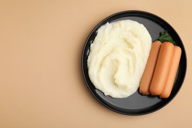 Photo of Delicious boiled sausages, mashed potato and parsley on beige background, top view. Space for text