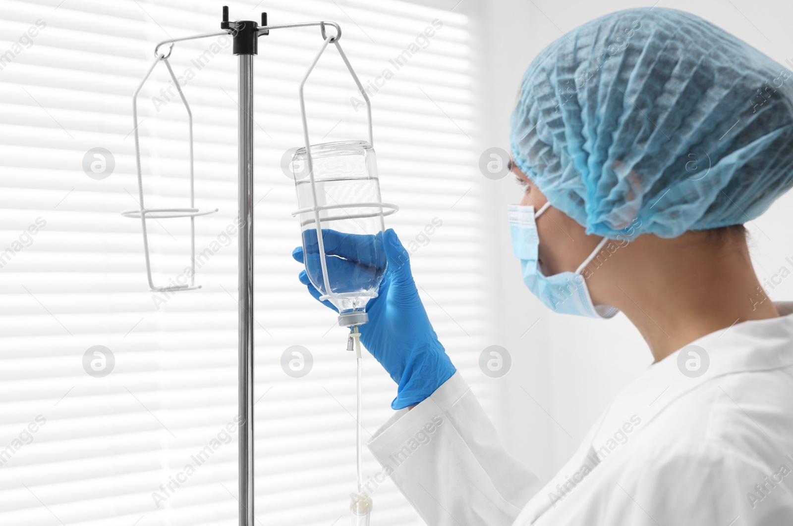 Photo of Nurse setting up IV drip in hospital