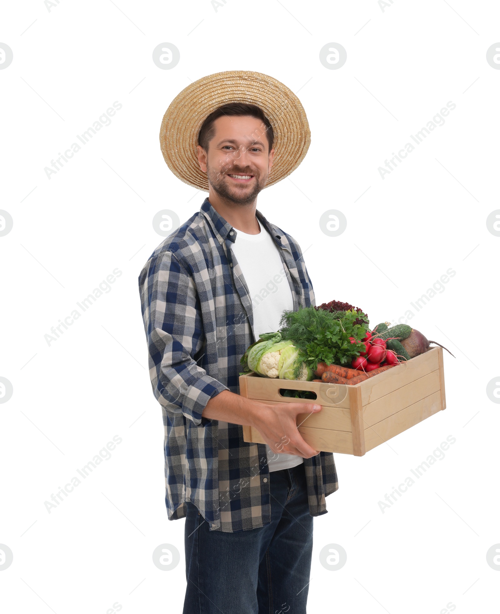 Photo of Harvesting season. Happy farmer holding wooden crate with vegetables on white background