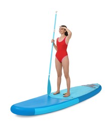 Photo of Happy woman with paddle on blue SUP board against white background