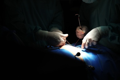 Medical team performing surgery in operating room, closeup