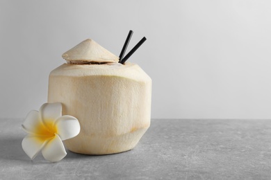 Photo of Fresh coconut drink in nut on table