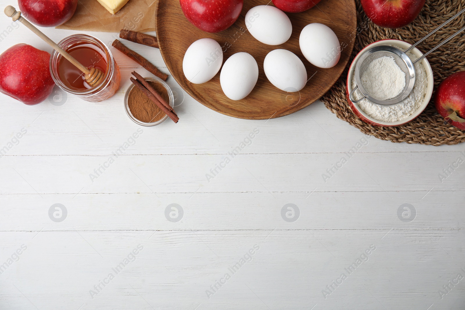 Photo of Traditional English apple pie ingredients on white wooden table, flat lay. Space for text