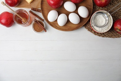 Traditional English apple pie ingredients on white wooden table, flat lay. Space for text