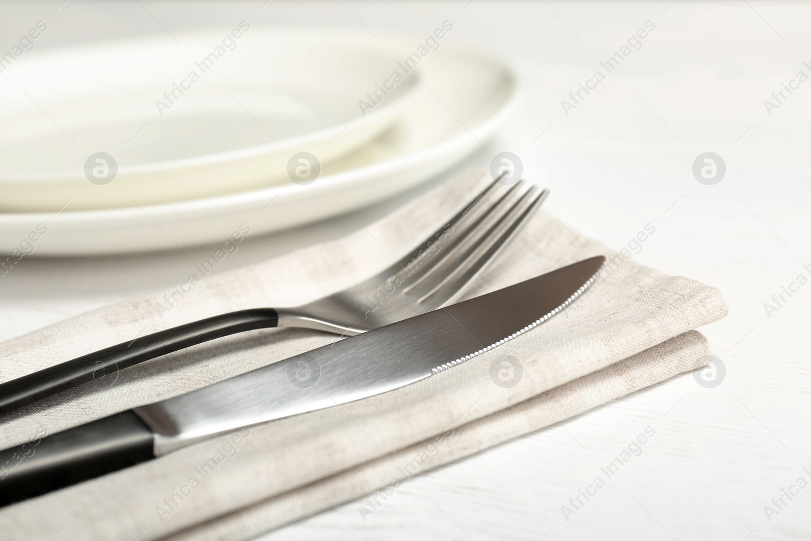 Photo of Fork and knife on table, closeup. New cutlery