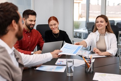 Team of employees working together in office