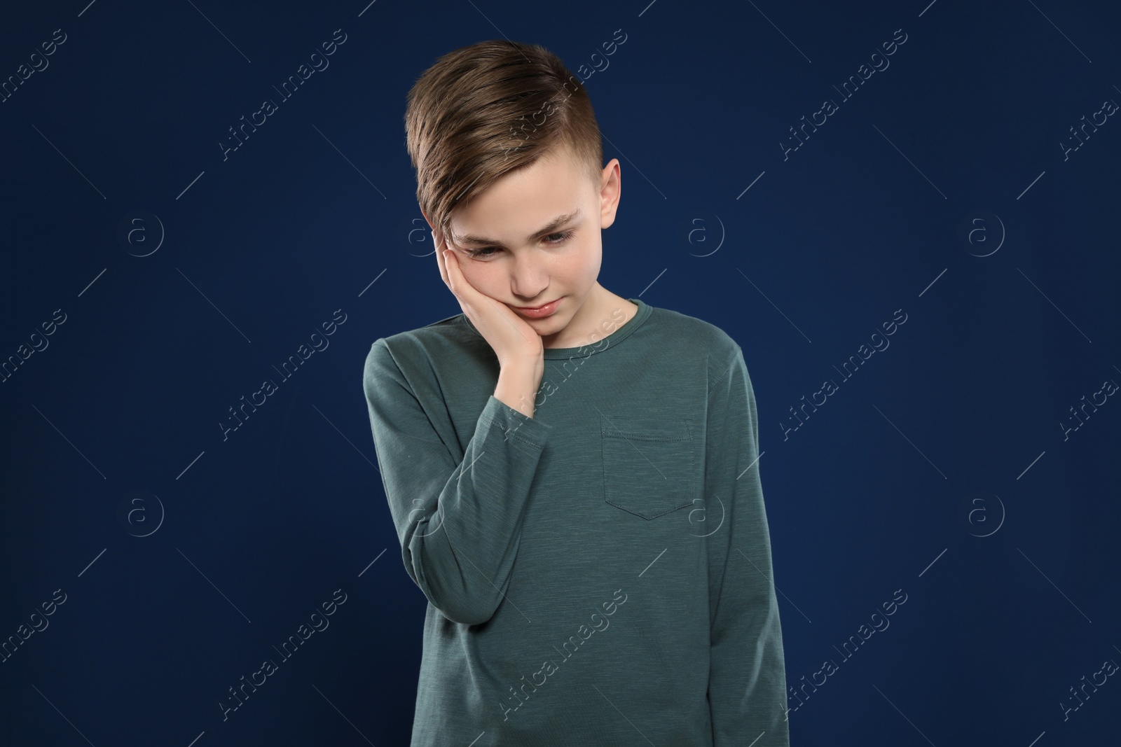 Photo of Portrait of emotional little boy on color background