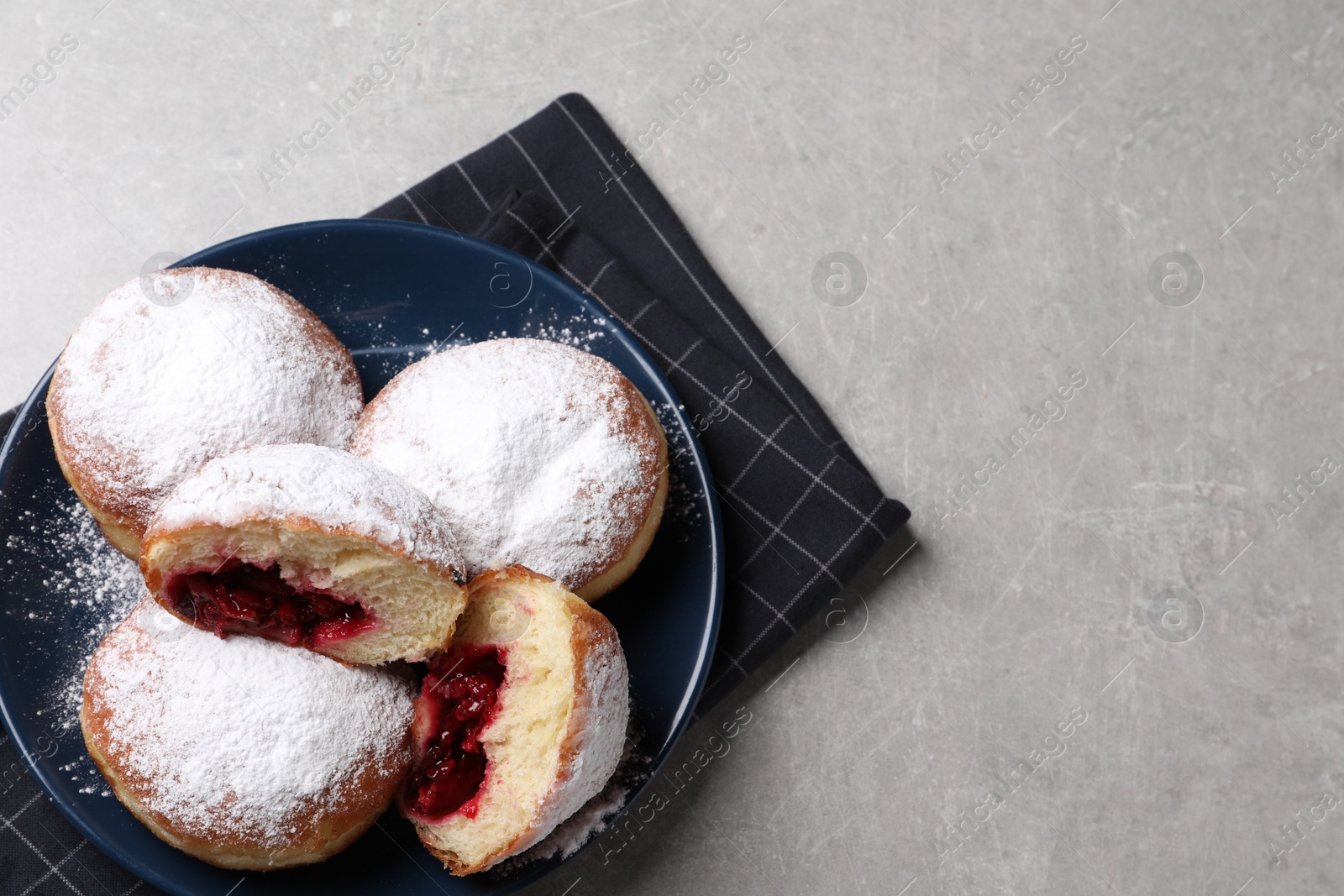 Photo of Delicious sweet buns with cherries on gray table, top view. Space for text