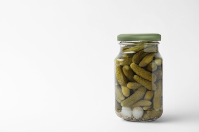 Photo of Jar with pickled gherkins on white background