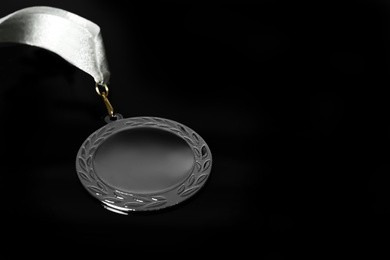 Silver medal on black background. Space for design