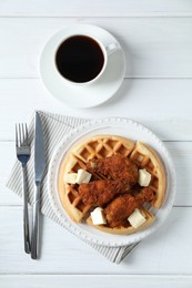 Photo of Delicious Belgium waffles served with fried chicken and butter on white table, flat lay