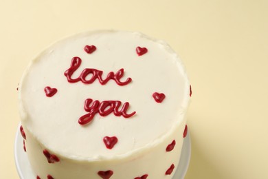 Bento cake with text Love You on beige table, closeup. St. Valentine's day surprise